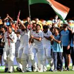 Indian team and management moving around the Gabba stadium, holding the Indian flag upright. After winning the 4th test against Australia and winning the series by 2-1.